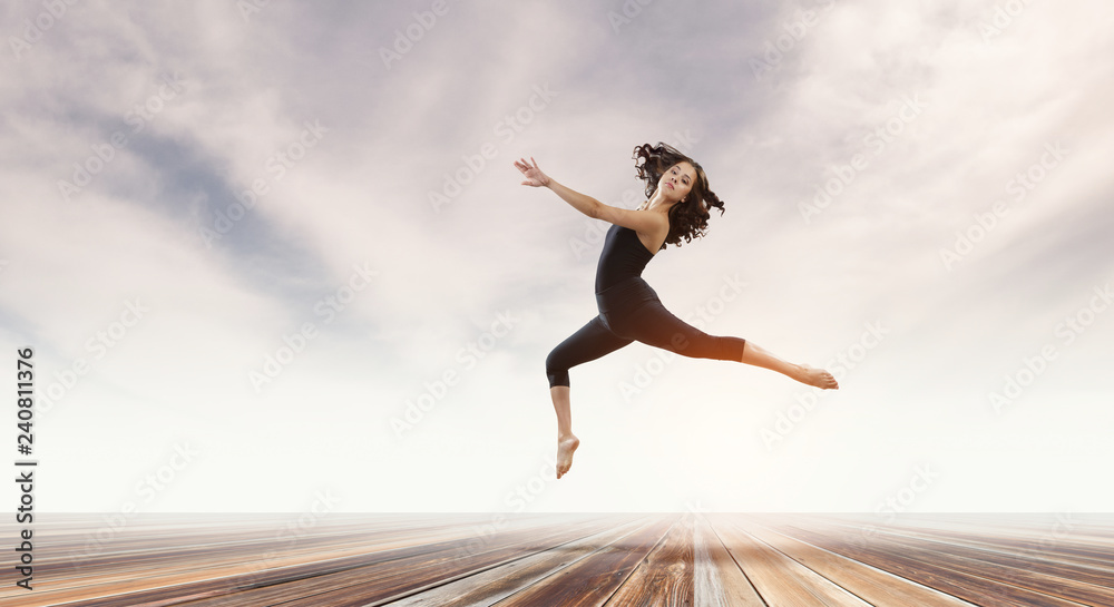 Fototapeta premium Gymnast girl in jump Mixed media