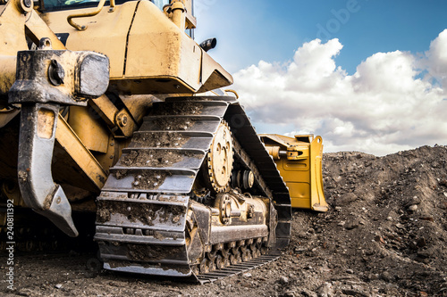 bulldozer moving dirt on the construction site photo