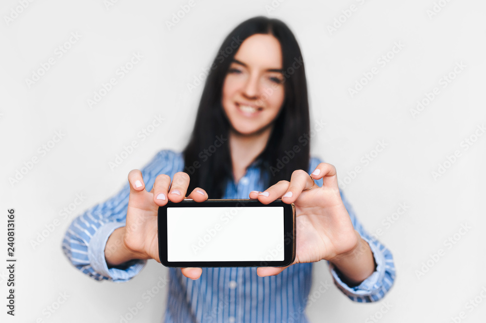 Beautiful girl show her smart phone. Empty black screen. Isolate.