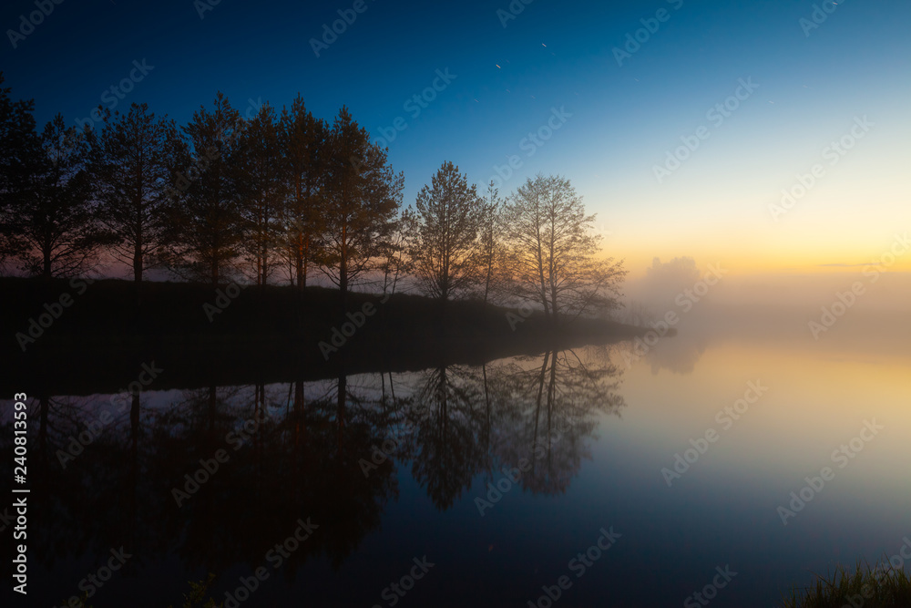 River shore, fog on the water and starry sky