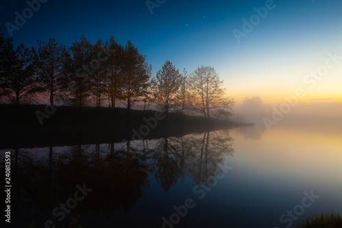 River shore  fog on the water and starry sky