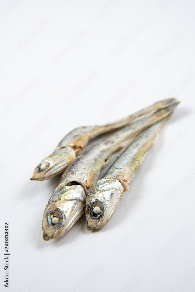 Dried anchovies used in Korean cuisine. Isolated on white background. Dried anchovies used in Korean cuisine. Isolated on white background.