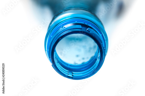 closeup of open plastic bottle neck on white background