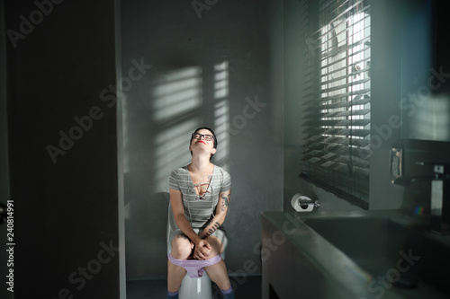 Woman Sitting on Toilet Smiling and Feeling Extreme Relief