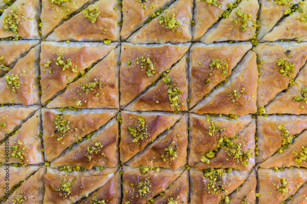 Baklava dessert. A sweet treat made with dough, honey, and pistachios, served in a Mediterranean restaurant. Dessert from Greece. 