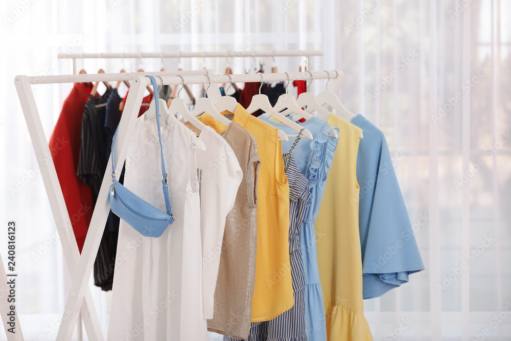 Racks with stylish clothes in light room Racks with stylish clothes in light room