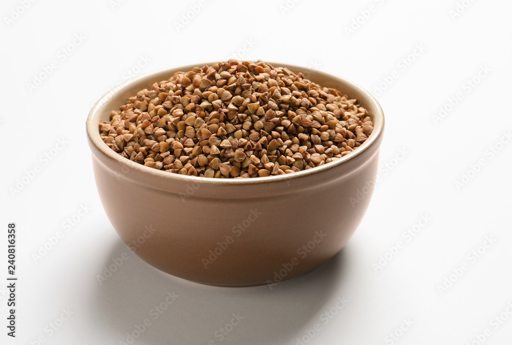 Bowl with buckwheat on white background. Natural food high in protein Bowl with buckwheat on white background. Natural food high in protein