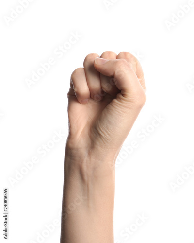 Young woman showing clenched fist on white background