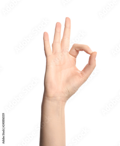 Young woman showing OK gesture on white background