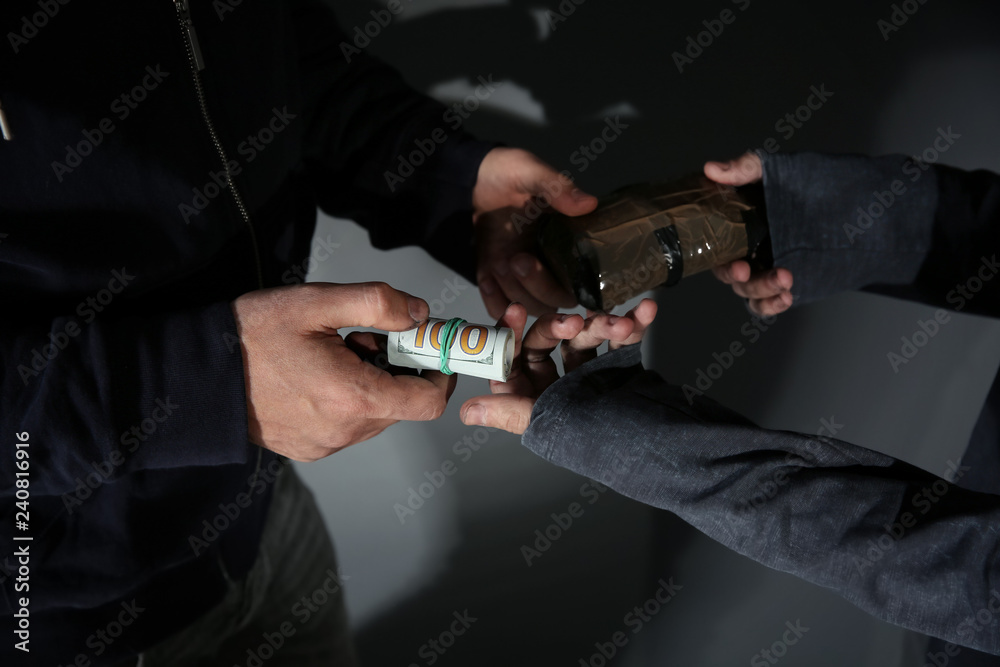 Addicted man buying drugs from dealer, focus on hands