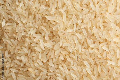 Canvastavla Raw parboiled rice as background, closeup view