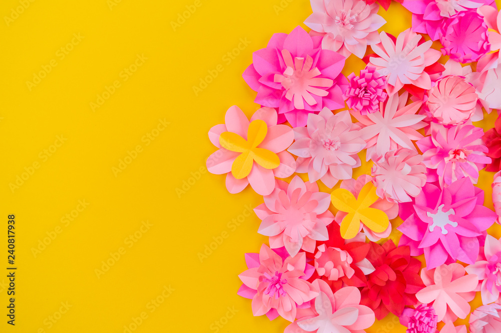 Obraz premium Flower made of coral color paper. The pink color of the curl and leaf.