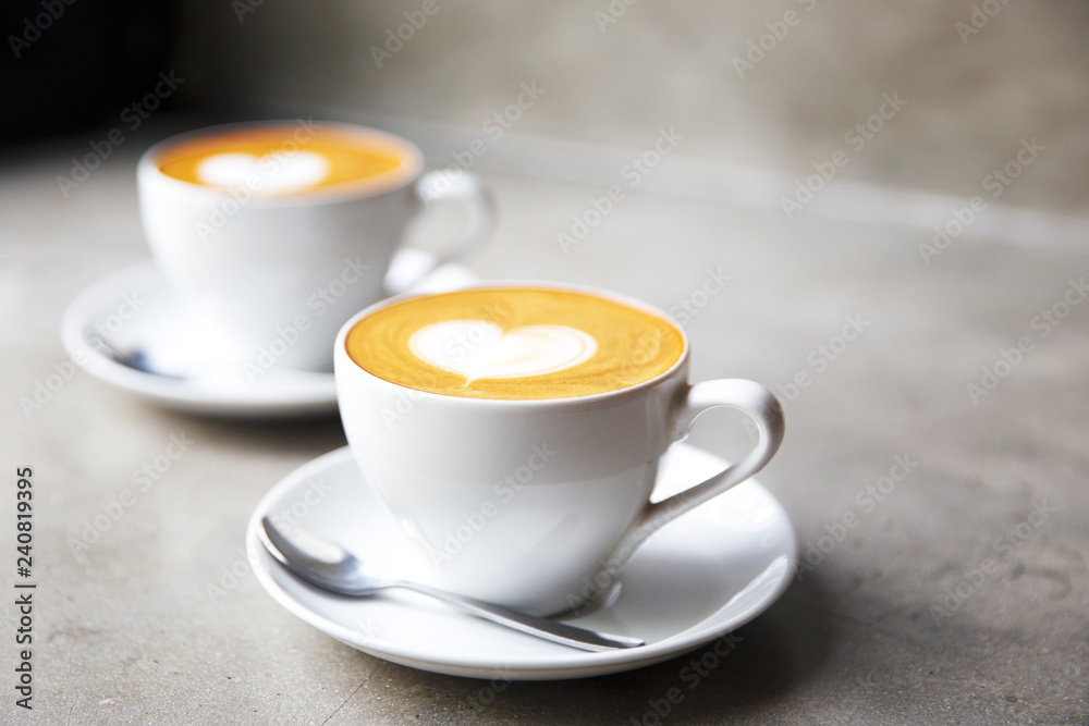 Two white cups of tasty cappucino with love art latte. Valentine's concept. Two white cups of tasty cappucino with love art latte. Valentine's concept.