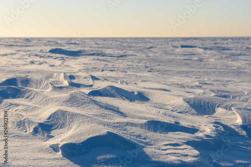 snow forms against the backdrop of the endless snowy landscape