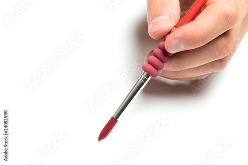 Men s hand holding color brush on isolated backgroung  close up
