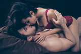 Close up photo of two people pair wife husband laying on sheets 