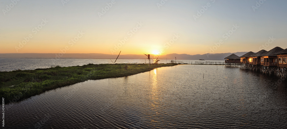 Small buildings on a water body in Myanmar