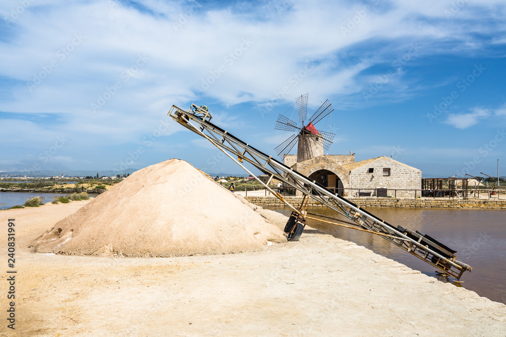 Heap of salt with a typical windmill at Trapani and Paceco salt evaporation ponds, Sicily, Italy Heap of salt with a typical windmill at Trapani and Paceco salt evaporation ponds, Sicily, Italy