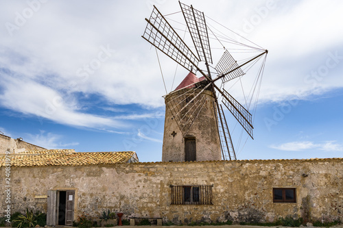 Typical old windmill now housing a salt museum (Museo del Sale) at Trapani salt evaporation ponds, Sicily, Italy