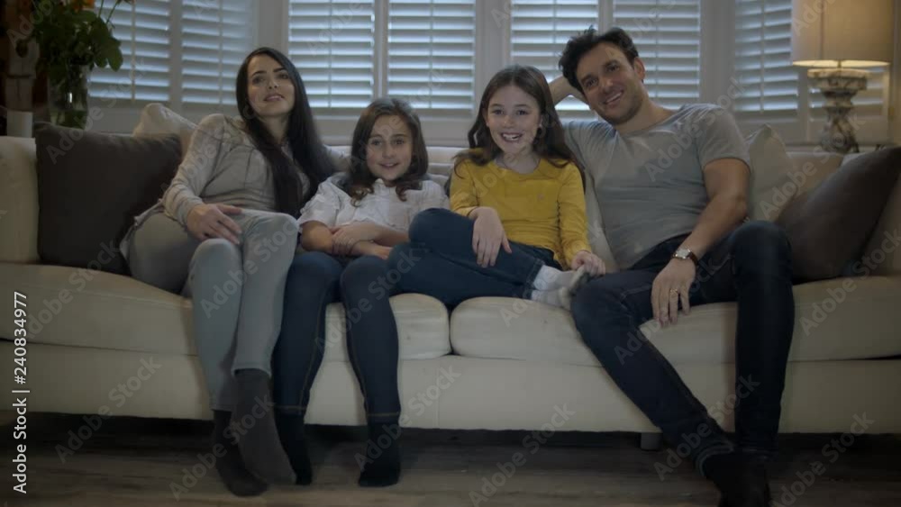 Happy Family Sitting On Sofa Watching Television. Happy Family Sitting On Sofa Watching Television.
