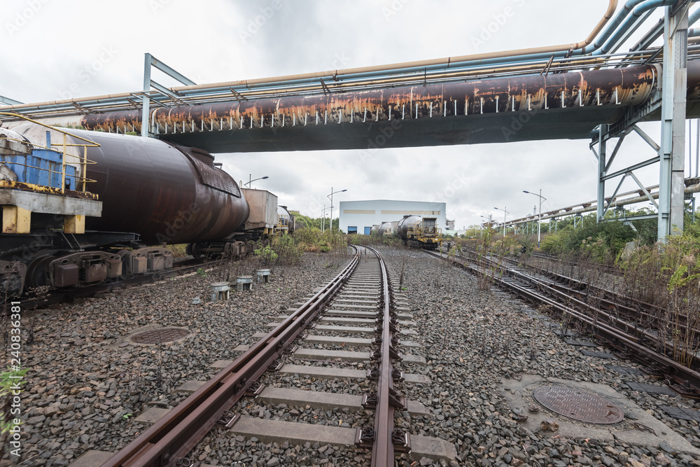 cargo trains stopped on old railroad in abandoned industrial site cargo trains stopped on old railroad in abandoned industrial site