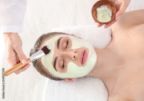 Cosmetologist applying mask...
