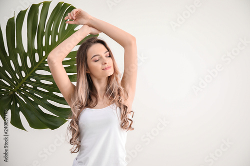 Beautiful young woman on white background. Concept of using deodorant photo