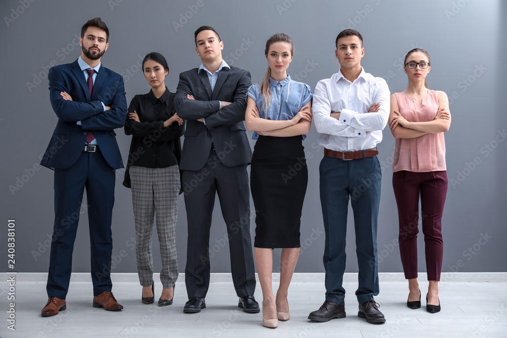 Obraz premium Team of young people near grey wall in office