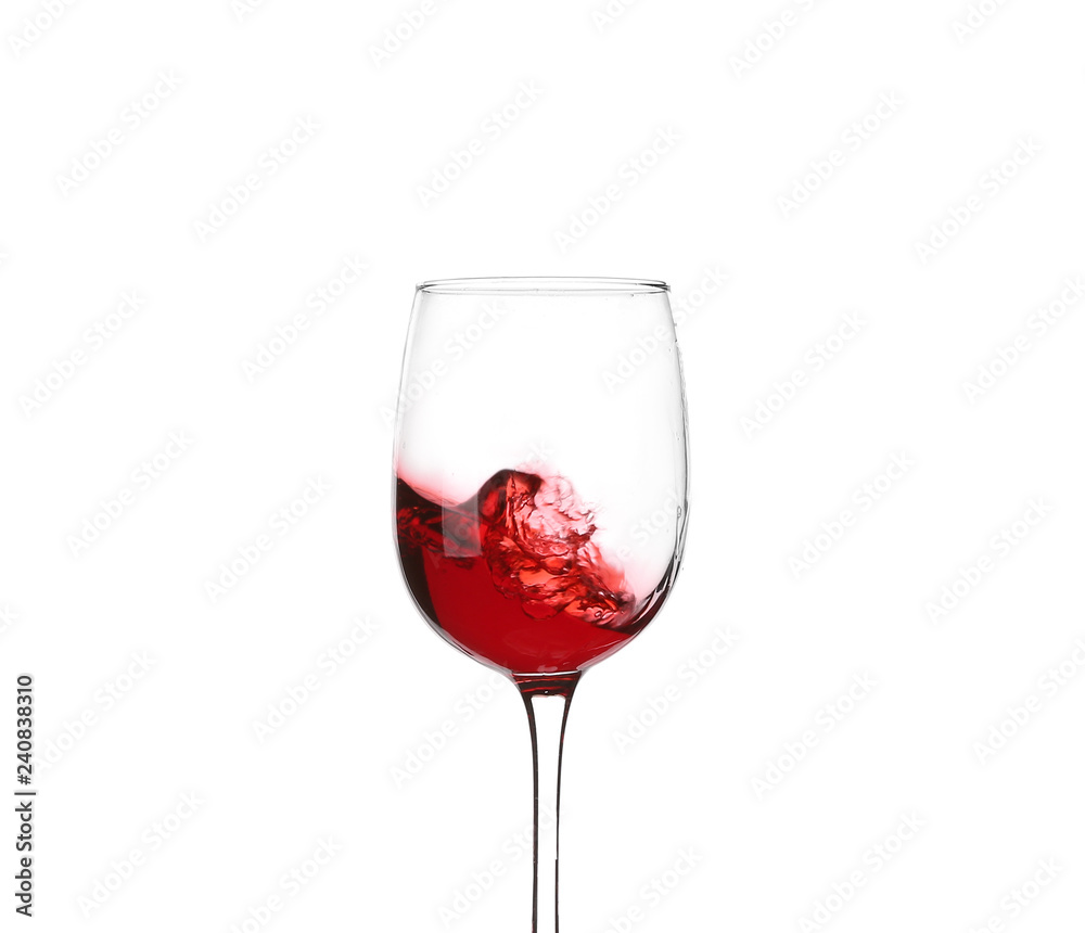 Glass with red splashing wine on white background Glass with red splashing wine on white background