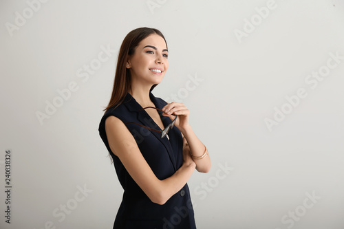 Portrait of beautiful businesswoman on light background