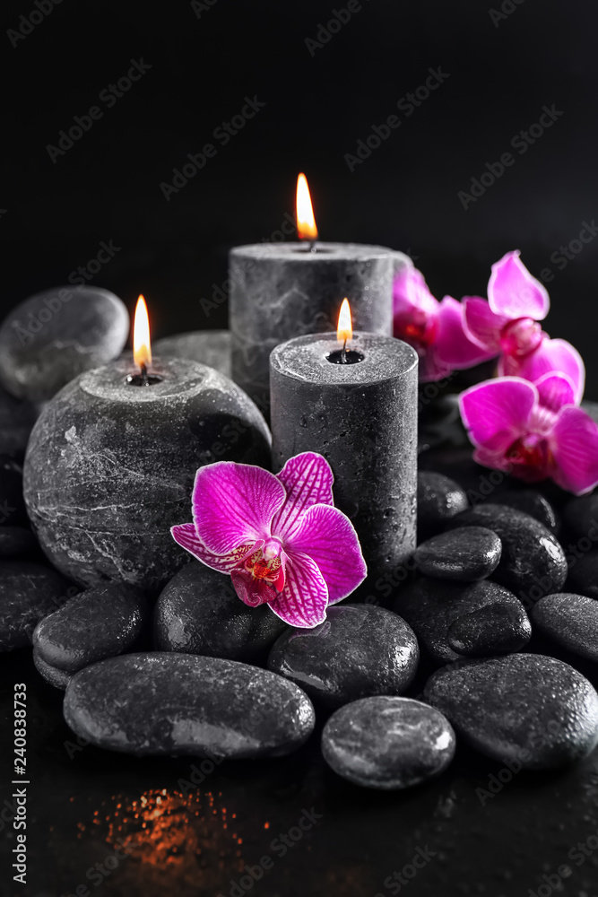 Candles, flowers and spa stones on dark background Candles, flowers and spa stones on dark background