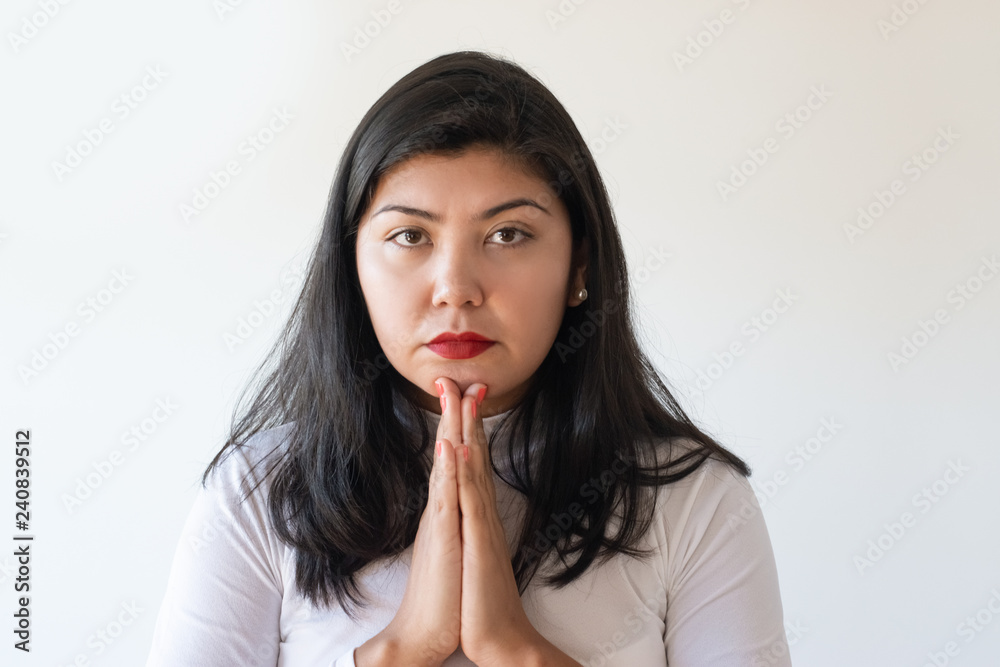 Serious Asian girl begging for help. Young woman putting hands together in pray and looking at camera. Praying concept Serious Asian girl begging for help. Young woman putting hands together in pray and looking at camera. Praying concept