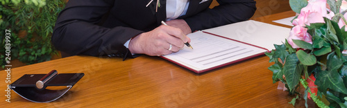 Фотография Man with Pen Signet a certificate on the Desk