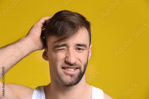 Foto Handsome man having half of his face shaved against color background