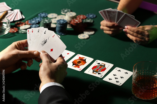 Male player at table in casino photo