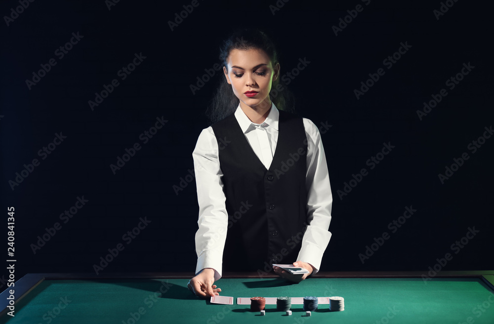 Beautiful female banker at table in casino