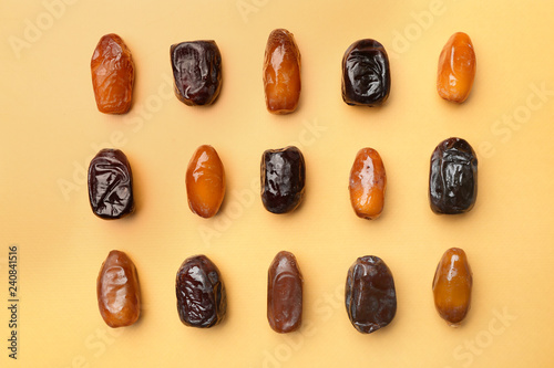 Sweet dried dates on color background