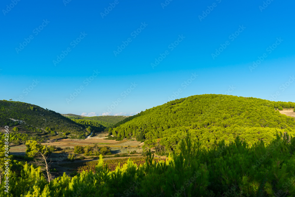 Greece, Zakynthos, Green hills and blue sky nature landscape in dawning atmosphere