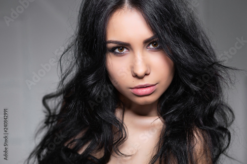 Charming young brunette posing in the studio