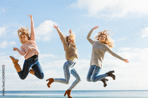 Three women jumping