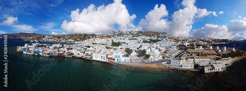 Aerial drone panoramic view of beautiful and popular Mykonos town with stunning clouds, Cyclades, Greece