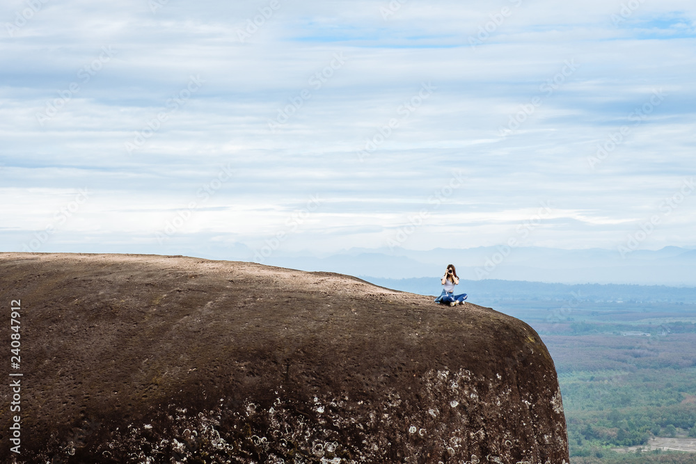 Obraz premium Woman Enjoy the Fresh Air and Embrace the Natureon the three whale rock mountain at Phu Sing , Bueng Kan Province,Thailand
