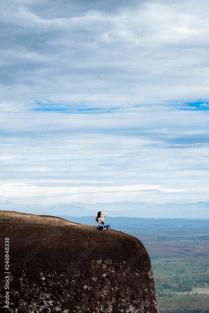 Fototapeta premium Woman Enjoy the Fresh Air and Embrace the Natureon the three whale rock mountain at Phu Sing , Bueng Kan Province,Thailand