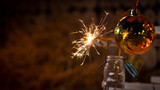 Rustic wooden wall with a sparkler and golden bokeh Christmas concept