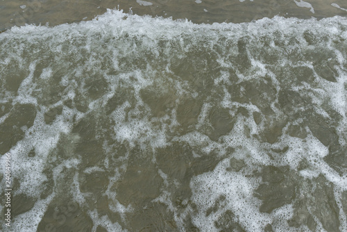 wave on a sandy beach as background