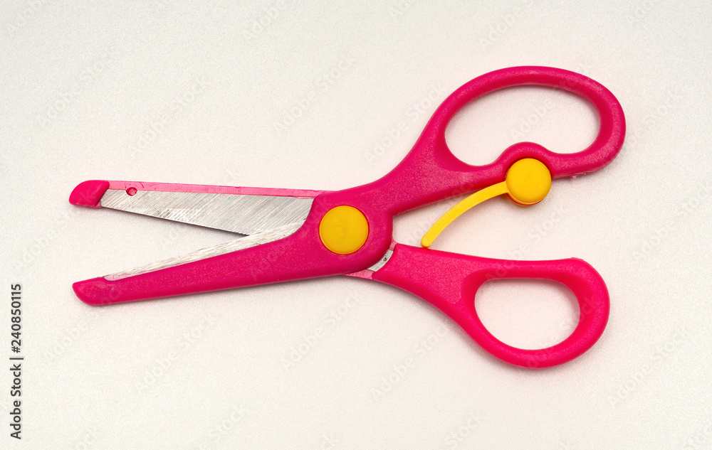 red handcraft scissors for children on a white background red handcraft scissors for children on a white background