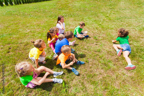 Top view of group of children playing on grass photo