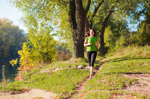 Young fit sport model running through the forest