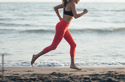 Sportswoman Running on Sandy Beach