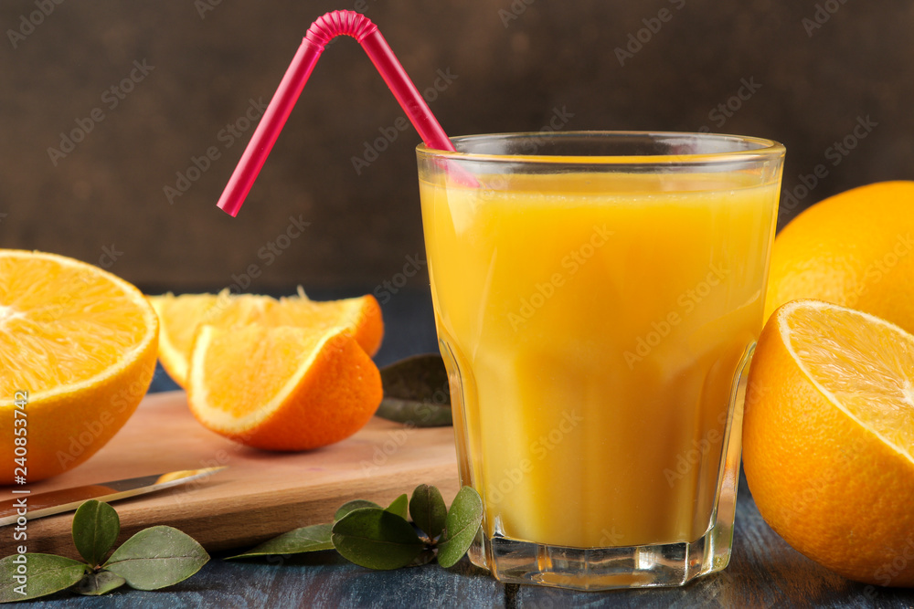 Citrus juices. Orange juice with fresh oranges on a blue wooden table. Citrus juices. Orange juice with fresh oranges on a blue wooden table.